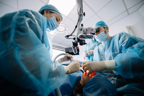 Surgeons performing operation in operating room.